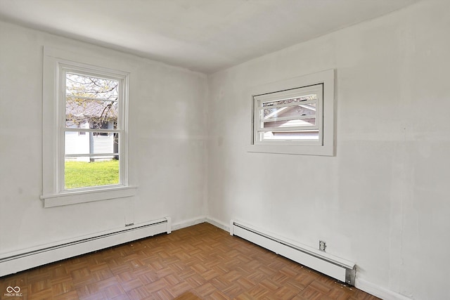 spare room with a baseboard heating unit and a wealth of natural light