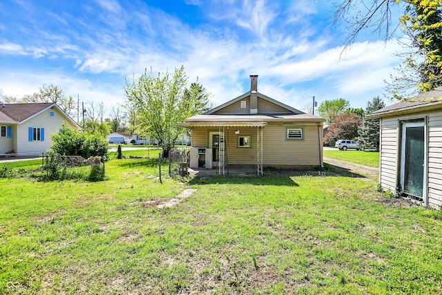 back of property featuring a yard