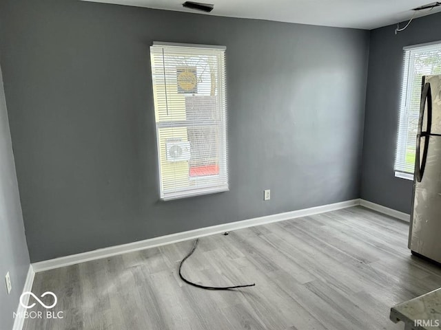 empty room featuring baseboards and wood finished floors