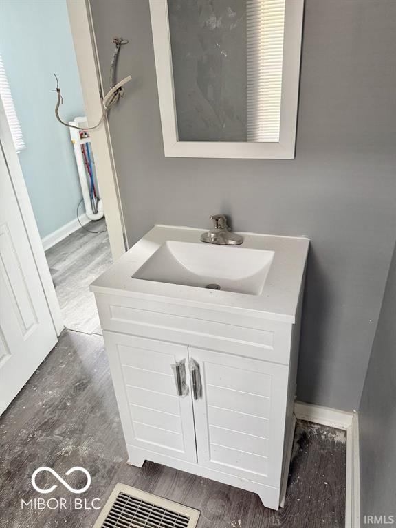 bathroom with wood finished floors and vanity