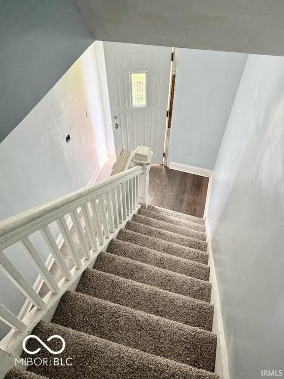 stairway with wood finished floors