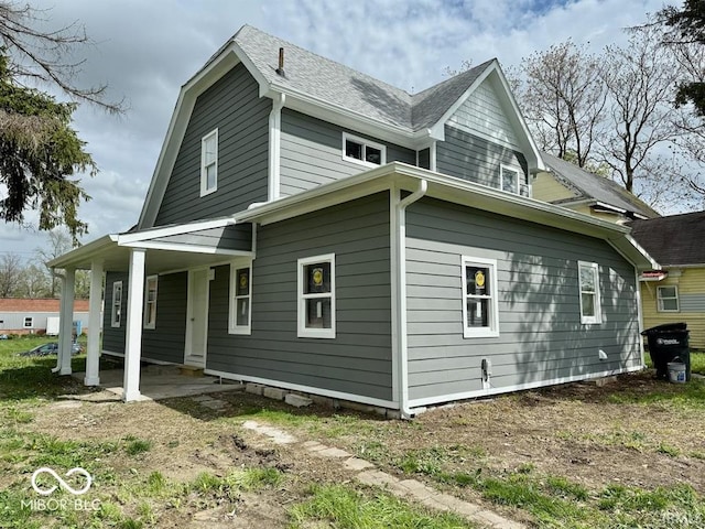 view of home's exterior featuring roof with shingles