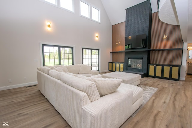 12520 E Stanley Rd, Selma, IN 47383 - living room featuring a healthy amount of sunlight, high vaulted ceiling, baseboards, and visible vents