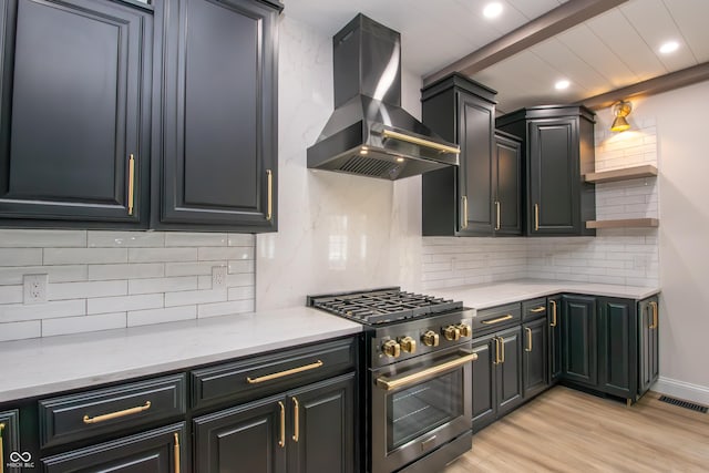 12520 E Stanley Rd, Selma, IN 47383 - kitchen with visible vents, high end stove, light wood finished floors, recessed lighting, and wall chimney exhaust hood
