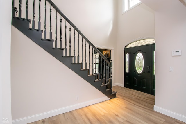 12520 E Stanley Rd, Selma, IN 47383 - foyer featuring stairway, baseboards, a high ceiling, and wood finished floors