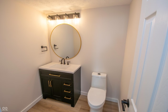 12520 E Stanley Rd, Selma, IN 47383 - bathroom with vanity, baseboards, wood finished floors, and toilet