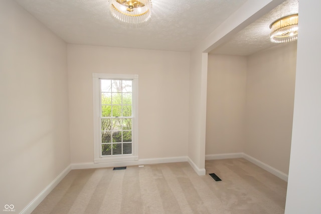 12520 E Stanley Rd, Selma, IN 47383 - empty room featuring an inviting chandelier, carpet floors, baseboards, and visible vents