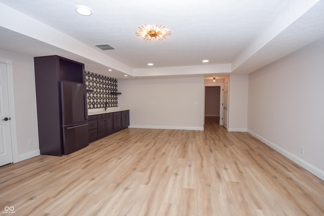 12520 E Stanley Rd, Selma, IN 47383 - unfurnished living room with baseboards, a dry bar, recessed lighting, and visible vents