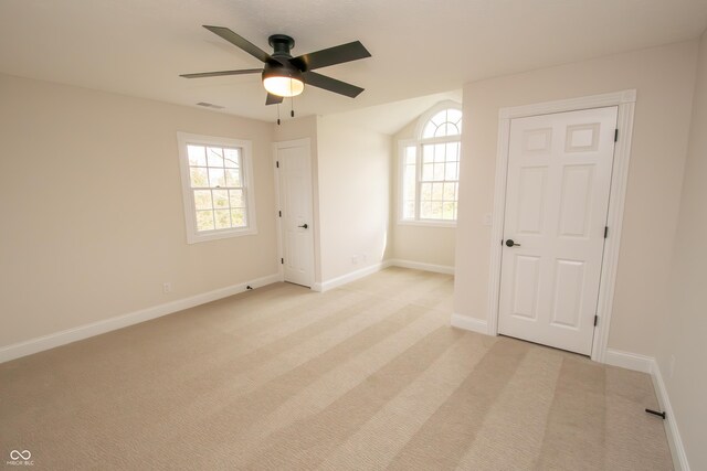 12520 E Stanley Rd, Selma, IN 47383 - spare room with visible vents, a ceiling fan, a healthy amount of sunlight, and light colored carpet