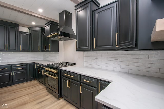 12520 E Stanley Rd, Selma, IN 47383 - kitchen with range with gas cooktop, range hood, light wood-type flooring, light stone counters, and recessed lighting
