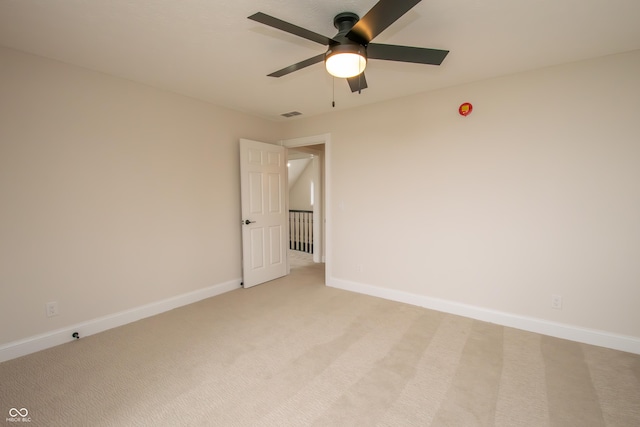 12520 E Stanley Rd, Selma, IN 47383 - spare room with baseboards, ceiling fan, visible vents, and light colored carpet