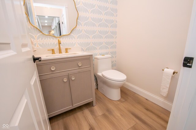 12520 E Stanley Rd, Selma, IN 47383 - bathroom with vanity, baseboards, toilet, and wood finished floors