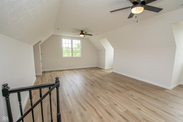12520 E Stanley Rd, Selma, IN 47383 - additional living space featuring a textured ceiling, ceiling fan, lofted ceiling, and light wood finished floors