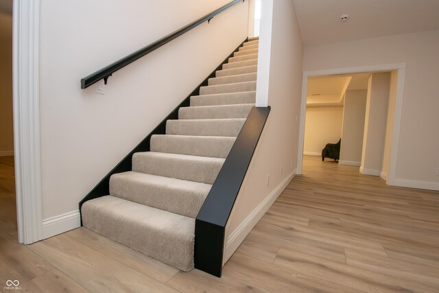 12520 E Stanley Rd, Selma, IN 47383 - stairs with baseboards and wood finished floors