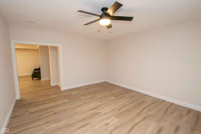 12520 E Stanley Rd, Selma, IN 47383 - unfurnished room with light wood-style floors, a ceiling fan, and baseboards