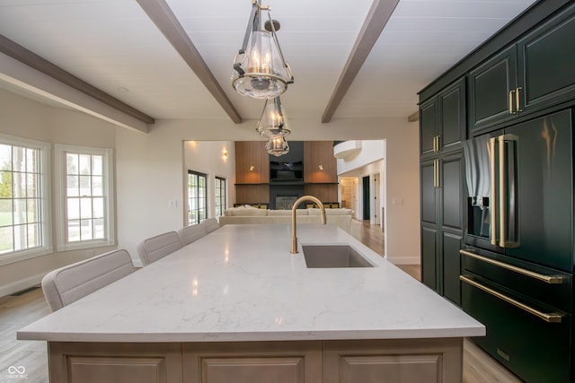 12520 E Stanley Rd, Selma, IN 47383 - kitchen featuring high end black fridge, beamed ceiling, open floor plan, an island with sink, and a sink