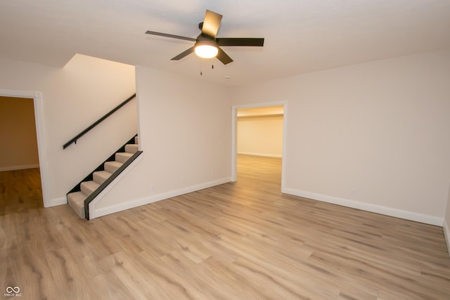 12520 E Stanley Rd, Selma, IN 47383 - unfurnished living room featuring light wood-type flooring, stairs, ceiling fan, and baseboards