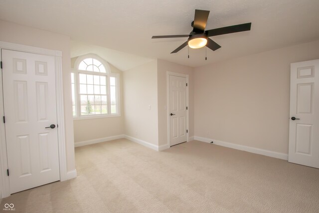 12520 E Stanley Rd, Selma, IN 47383 - unfurnished bedroom with a ceiling fan, baseboards, vaulted ceiling, and light carpet