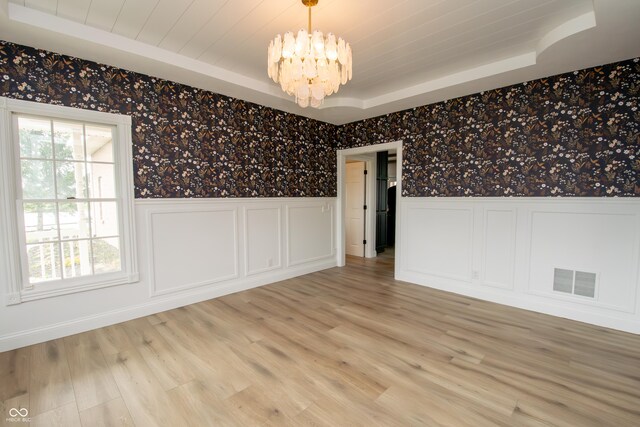 12520 E Stanley Rd, Selma, IN 47383 - empty room with wallpapered walls, an inviting chandelier, wainscoting, and visible vents
