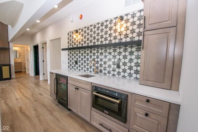 12520 E Stanley Rd, Selma, IN 47383 - kitchen featuring open shelves, a sink, wine cooler, light wood-style flooring, and oven