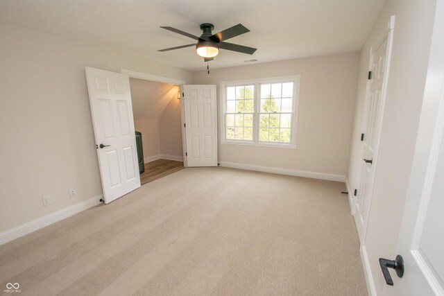 12520 E Stanley Rd, Selma, IN 47383 - unfurnished bedroom with baseboards, ceiling fan, and light colored carpet