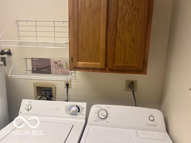 laundry room with cabinet space and washing machine and clothes dryer