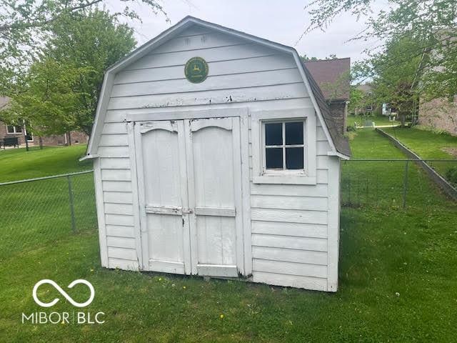 view of shed featuring fence