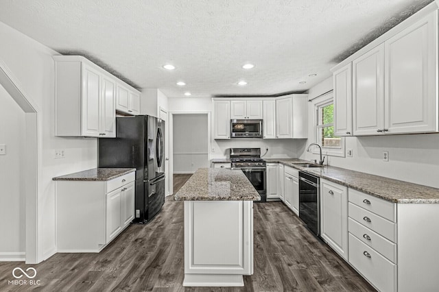 kitchen featuring a sink, a textured ceiling, appliances with stainless steel finishes, and white cabinets
