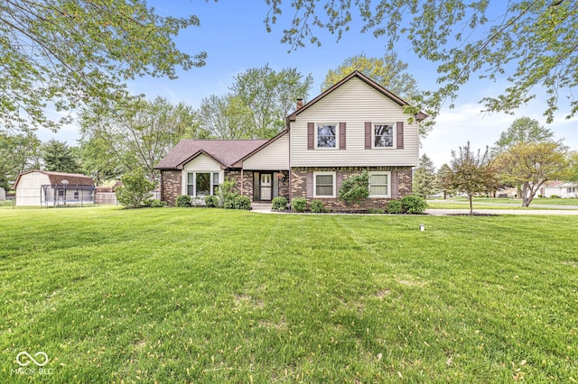 view of front of house featuring fence, a chimney, and a front lawn