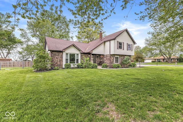 view of front of home with roof with shingles, fence, a front yard, and a chimney