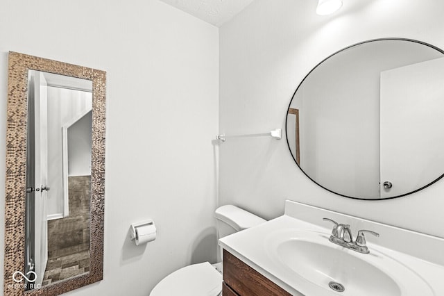 bathroom with toilet and vanity