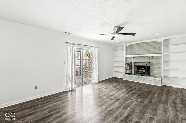 unfurnished living room with ceiling fan, a fireplace, a textured ceiling, wood finished floors, and visible vents