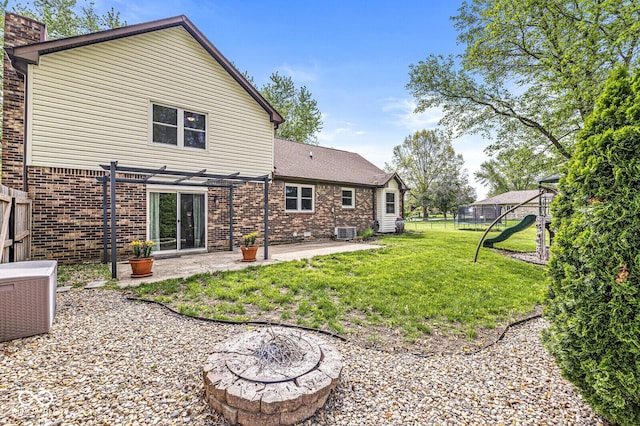 back of house with a patio, a playground, brick siding, and cooling unit