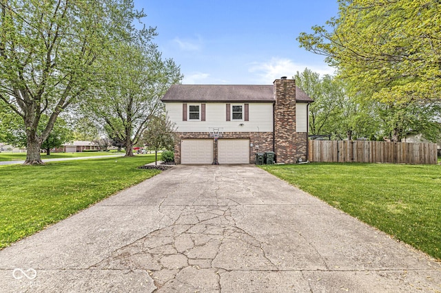 view of front facade featuring driveway, a chimney, fence, a front lawn, and an attached garage