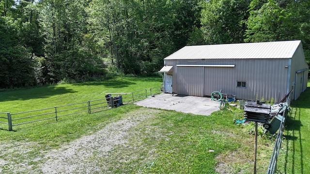 3282 S Conservation Club Rd, Morgantown, IN 46160 - view of yard featuring an outbuilding, a garage, and a wooded view