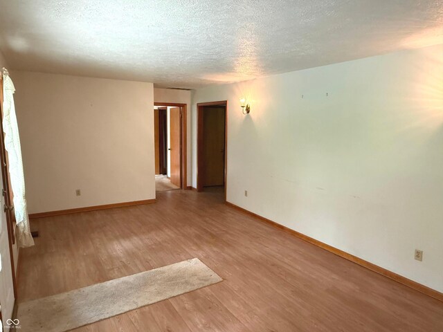 3282 S Conservation Club Rd, Morgantown, IN 46160 - spare room featuring light wood-style floors and a textured ceiling