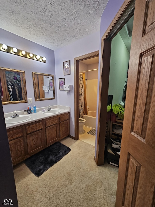 bathroom featuring double vanity, toilet, a sink, and shower / bath combo