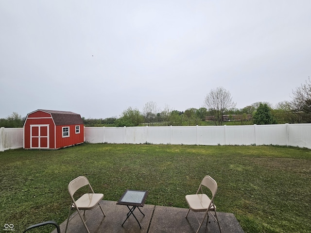view of yard featuring a fenced backyard, a storage unit, an outbuilding, and a patio area