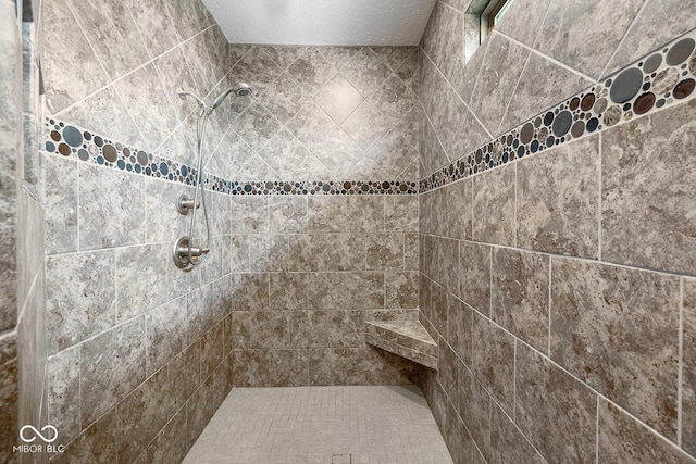 5136 Centerview Dr, Battle Ground, IN 47920 - bathroom featuring a textured ceiling and tiled shower