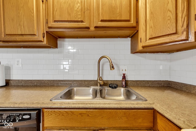 kitchen featuring a sink, tasteful backsplash, and dishwasher