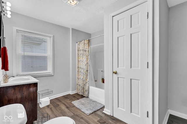full bath with vanity, toilet, shower / bath combination with curtain, baseboards, and wood finished floors