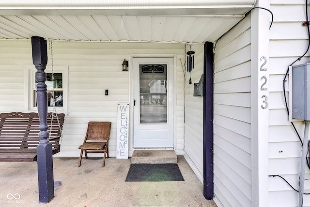 view of exterior entry featuring a porch
