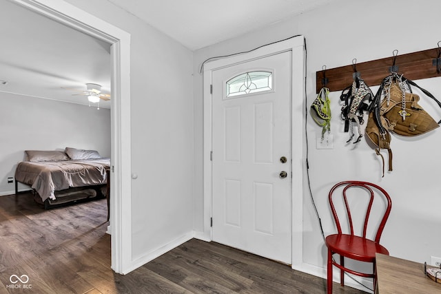 entryway featuring baseboards, ceiling fan, and dark wood finished floors