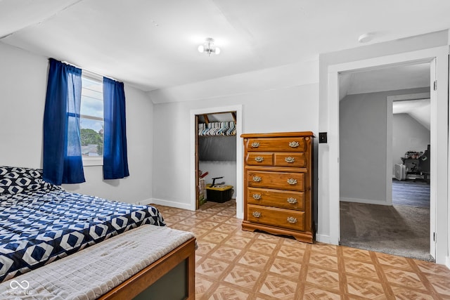 bedroom with baseboards and vaulted ceiling