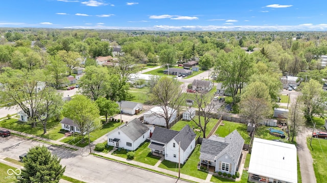 aerial view featuring a wooded view and a residential view