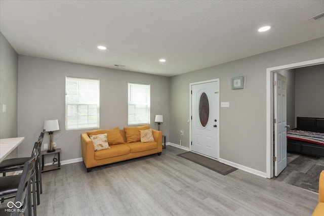 entrance foyer with baseboards, recessed lighting, and light wood-style flooring