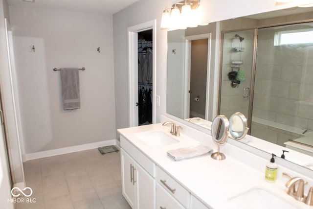 9176 Springbrook Dr, Pendleton, IN 46064 - full bathroom featuring a shower stall, double vanity, a walk in closet, tile patterned flooring, and baseboards