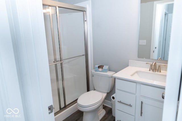 9176 Springbrook Dr, Pendleton, IN 46064 - bathroom with vanity, a stall shower, toilet, and wood finished floors