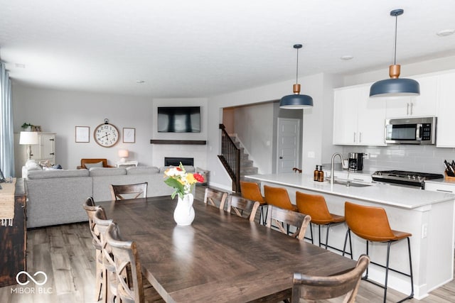 9176 Springbrook Dr, Pendleton, IN 46064 - dining space with light wood-type flooring and a fireplace