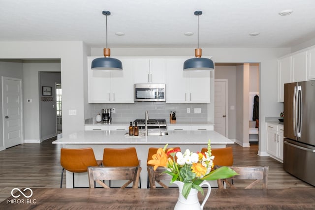 9176 Springbrook Dr, Pendleton, IN 46064 - kitchen with appliances with stainless steel finishes, tasteful backsplash, dark wood-style flooring, and baseboards